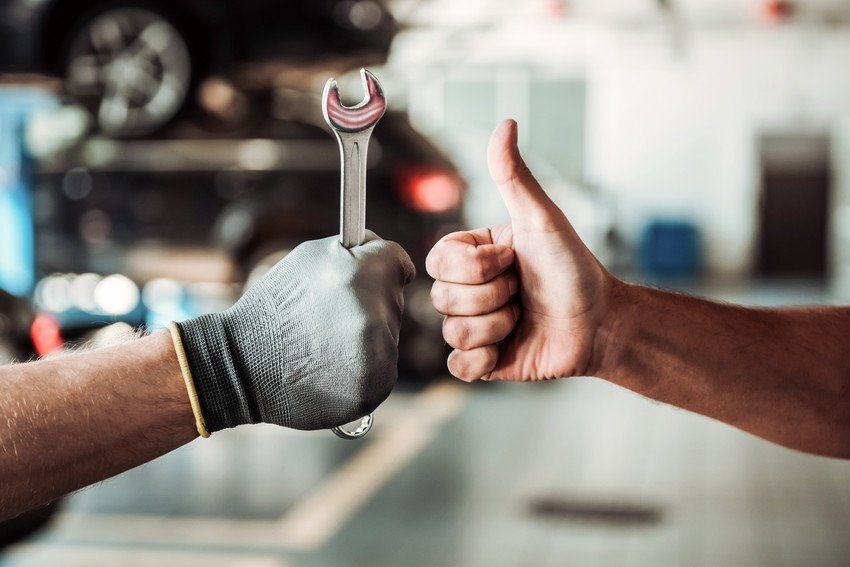 mechanic holding spanner