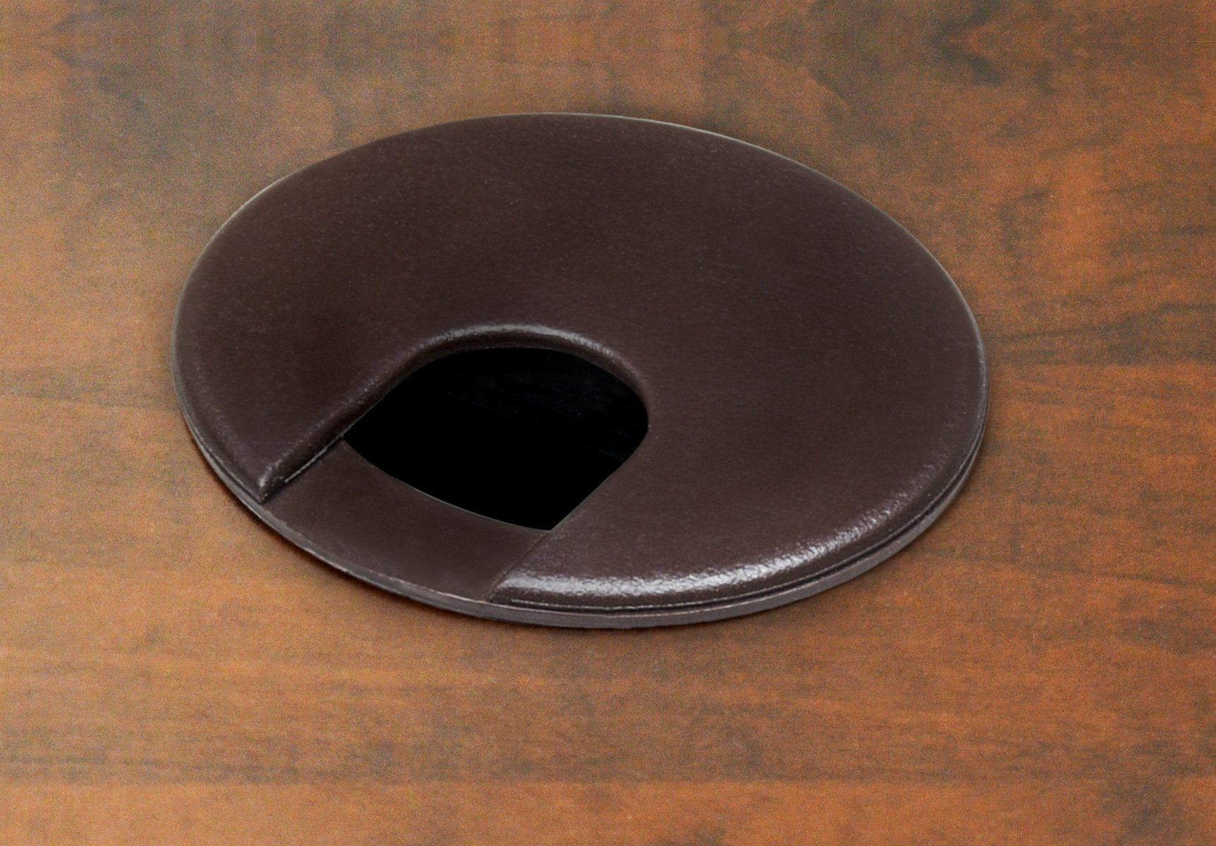 A brown circle with a hole in the middle on a wooden surface.