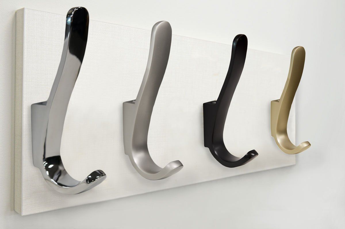 A row of hooks in different colors on a white board