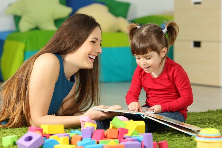 Child Care Transportation — Teacher Enjoying Teaching Child in Grants Pass, OR