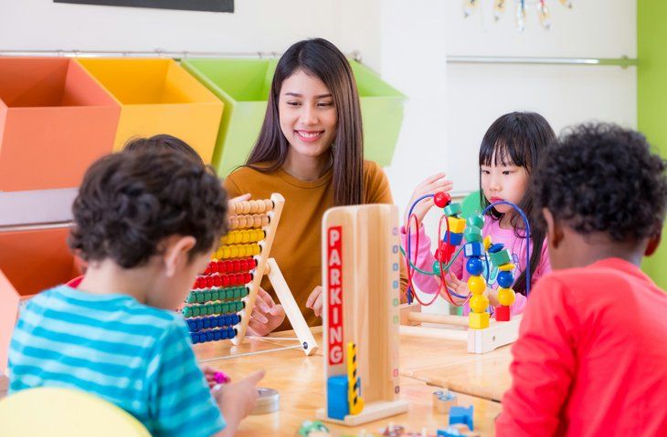 School Age Childcare — Woman Playing With Kids in Grants Pass, OR
