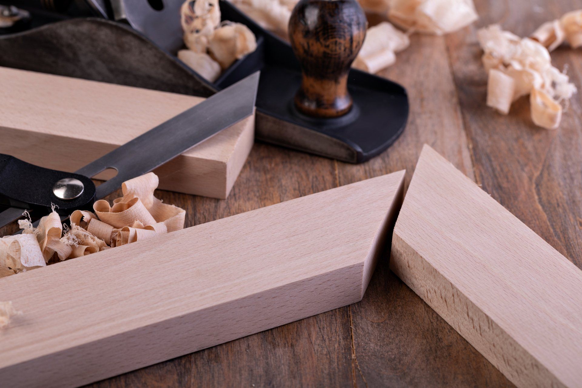A wooden table topped with pieces of wood and tools.