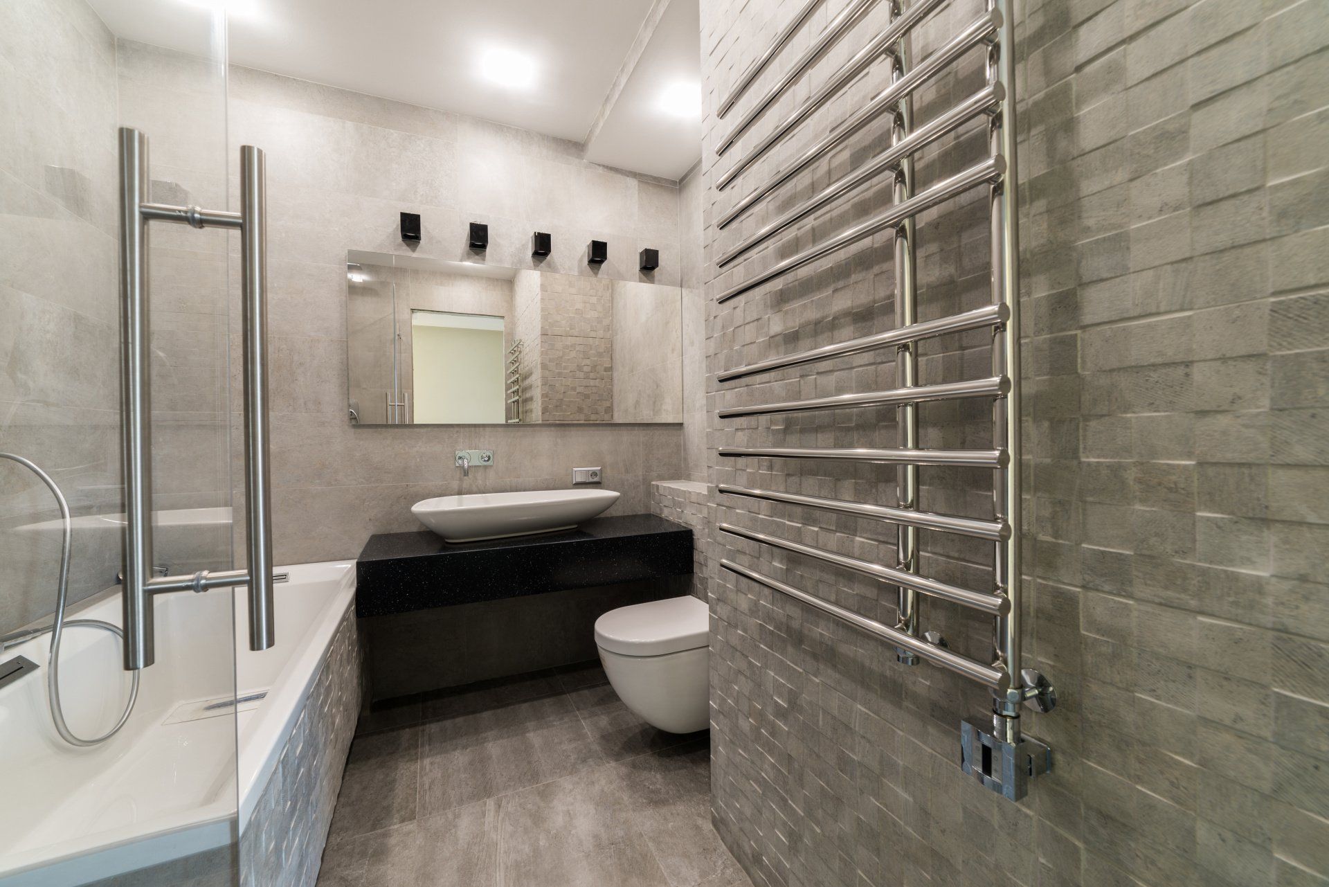 A bathroom with a toilet , sink , and towel rack.