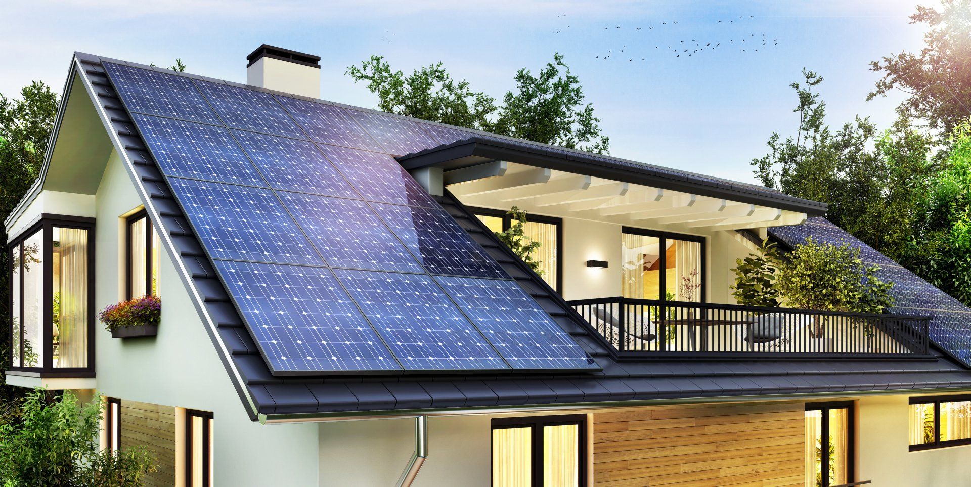 A house with solar panels on the roof is surrounded by trees.