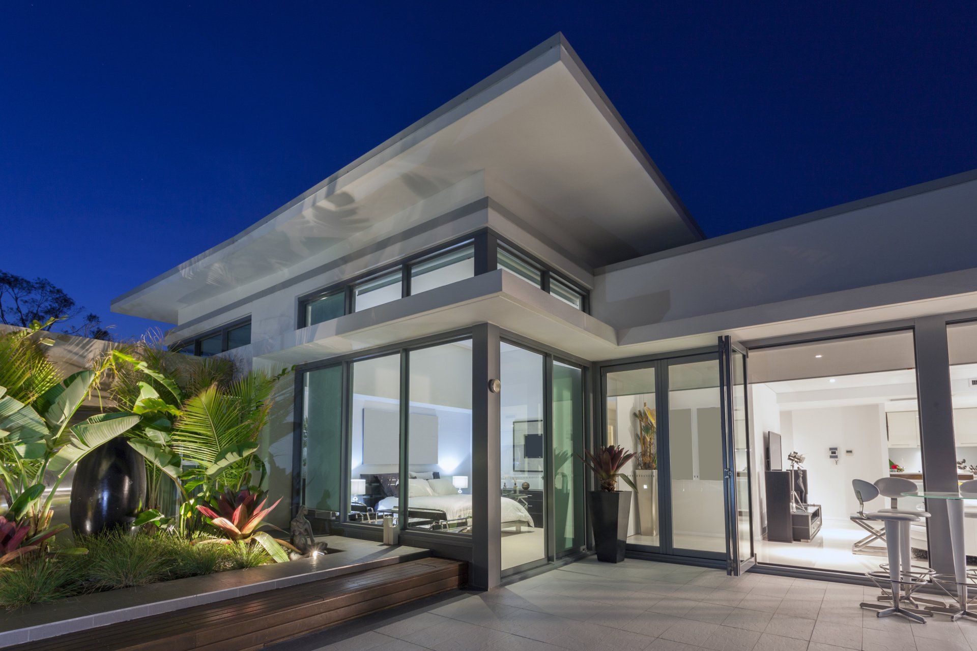 A modern house with a lot of windows and sliding glass doors