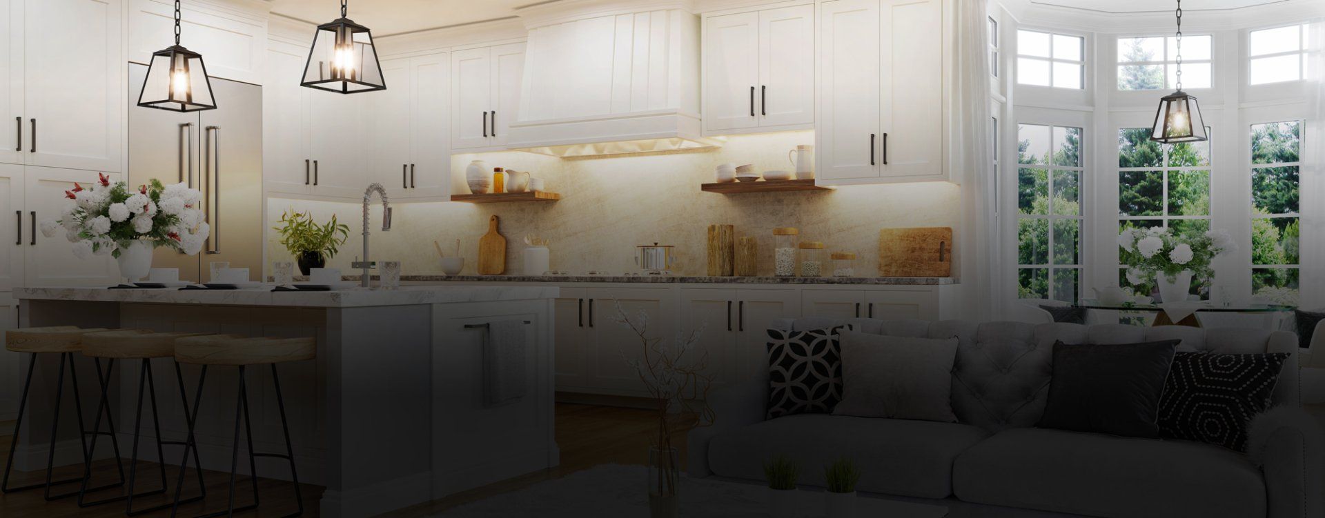 A kitchen with white cabinets and a living room with a couch.