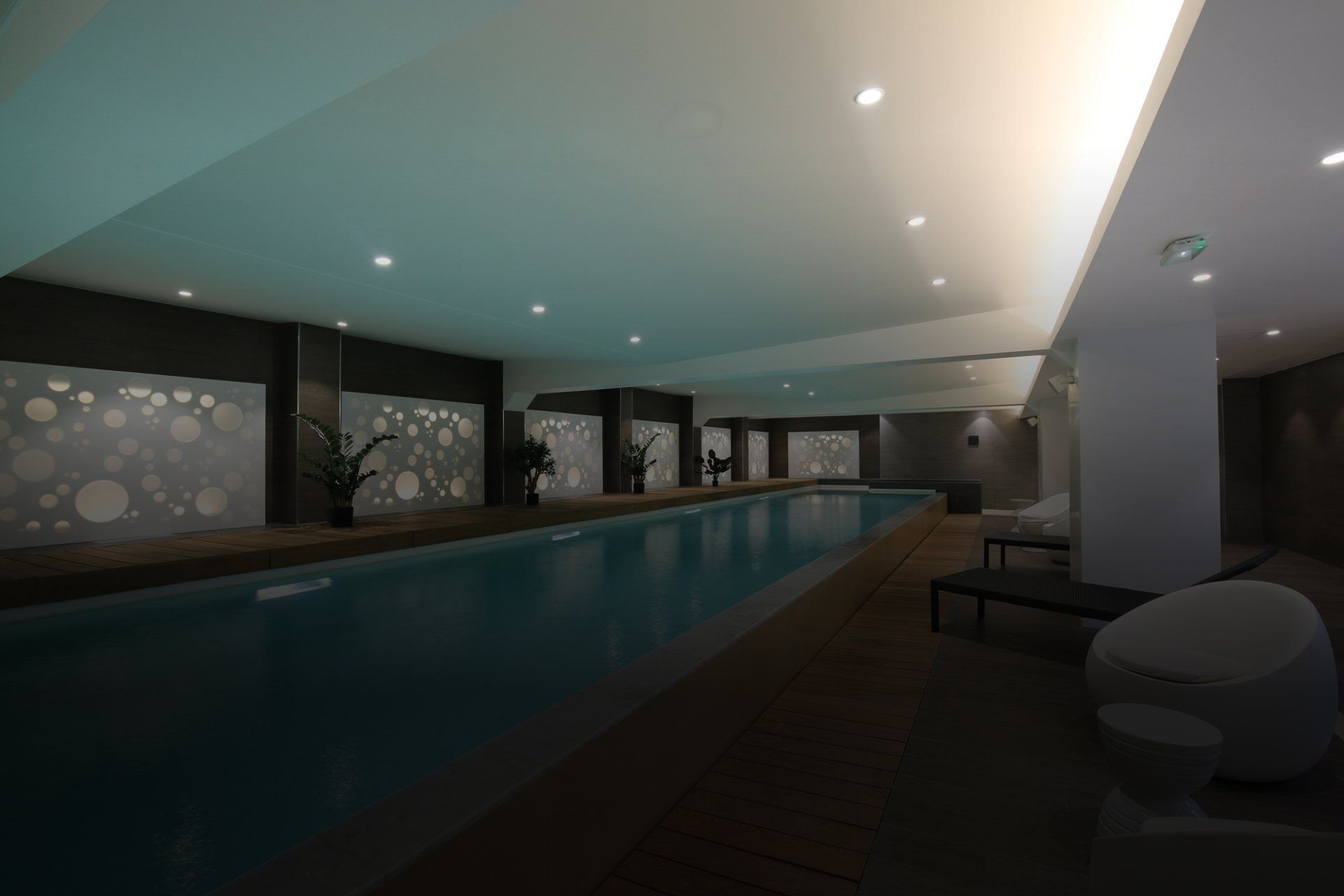 An artist 's impression of an indoor swimming pool in a building.