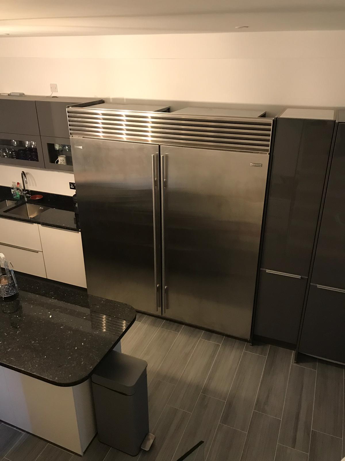 A kitchen with a stainless steel refrigerator and freezer.