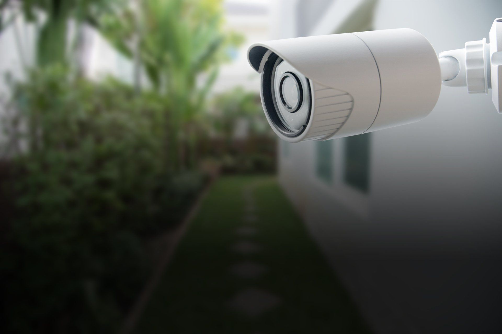 A security camera is mounted on the side of a building.