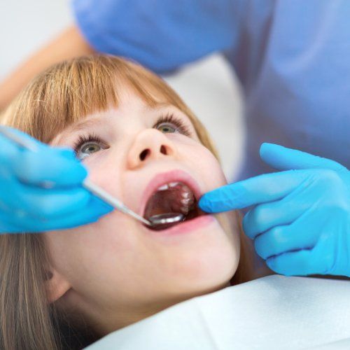 young boy getting his teeth checked