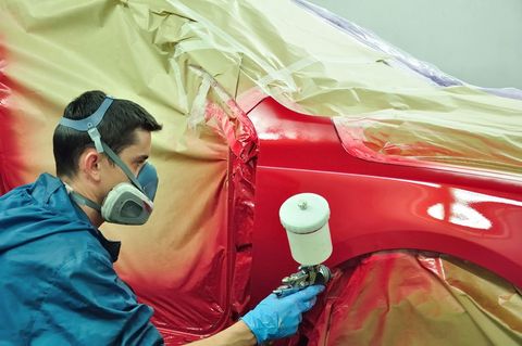 Worker Painting A Red Car — Summerville, SC — Hoelz’s Body Shop Worker Painting A Red Car — Summerville, SC — Hoelz’s Body Shop