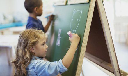 children writing on the board