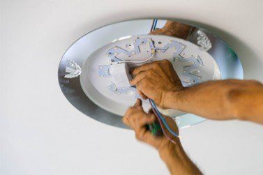 Electrician fixing ceiling fan—electrician in Sequim, WA
