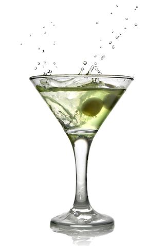 A martini glass with a green olive in it