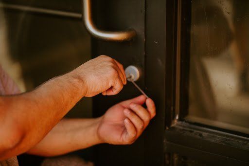APD Locksmith Business Lockout — Woman Opening Door with Key in Bellevue, NE APD Locksmith Business Lockout — Woman Opening Door with Key in Bellevue, NE