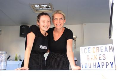 Two vendors smile for a photo at the San Luis Obispo Farmers Market