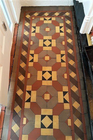 A long hallway with a geometric pattern on the floor