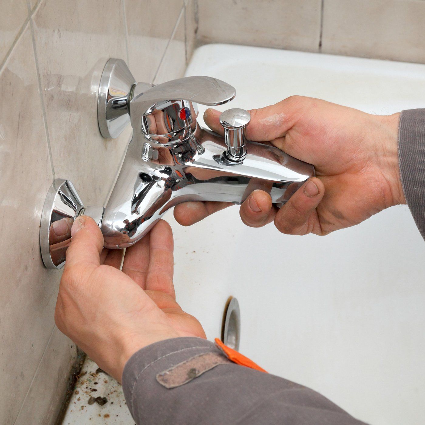Plumber Installing Faucet — Fostoria, OH — Roto Rooter of Fostoria Plumber Installing Faucet — Fostoria, OH — Roto Rooter of Fostoria