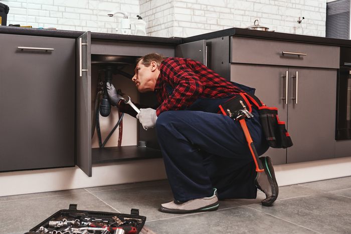 Plumber Fixing Drain Pipe — Fostoria, OH — Roto Rooter of Fostoria