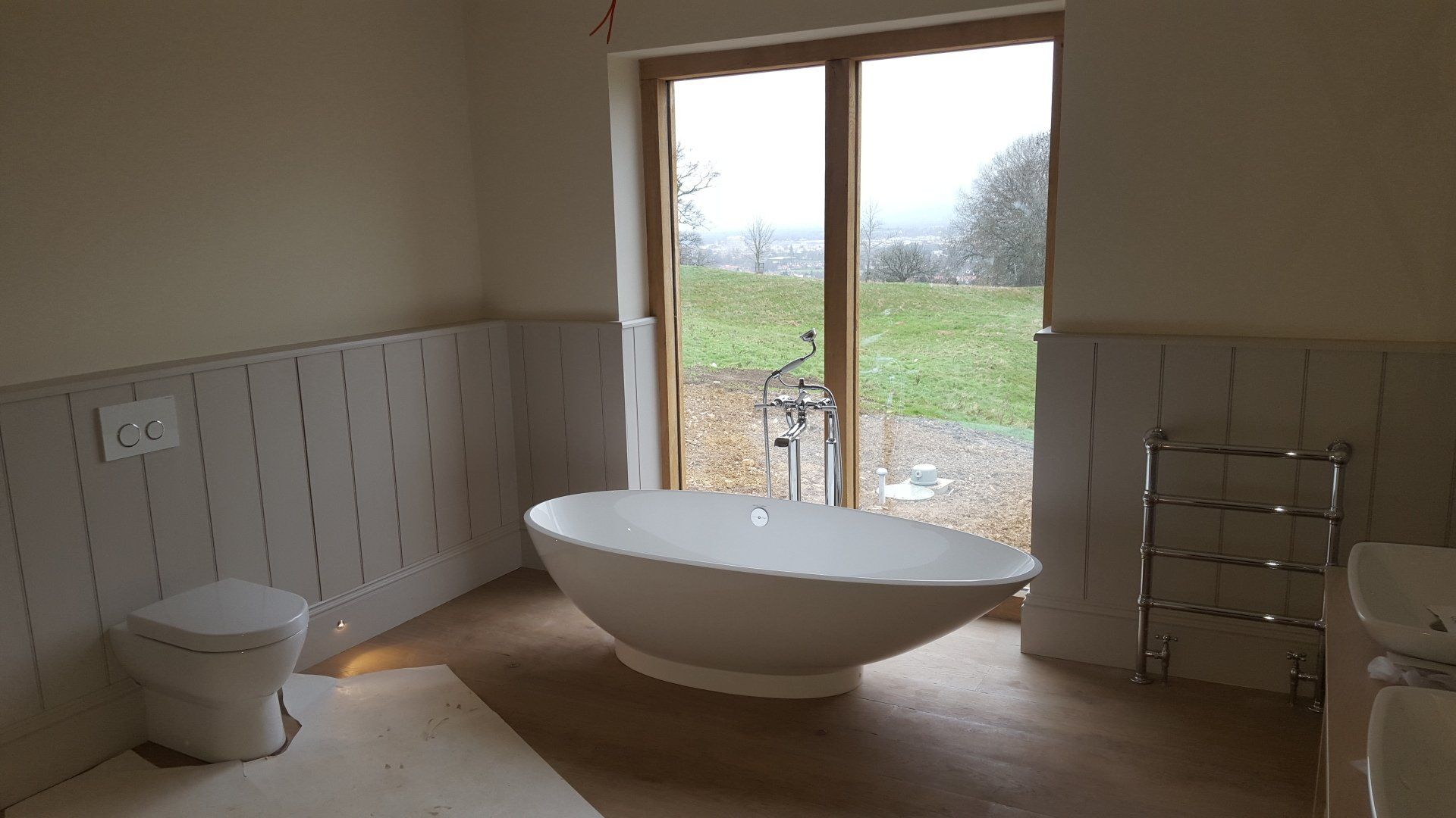 Bathroom in Cheltenham with hand painted paneling and vanity unit, decoration done in Farrow and Ball paint