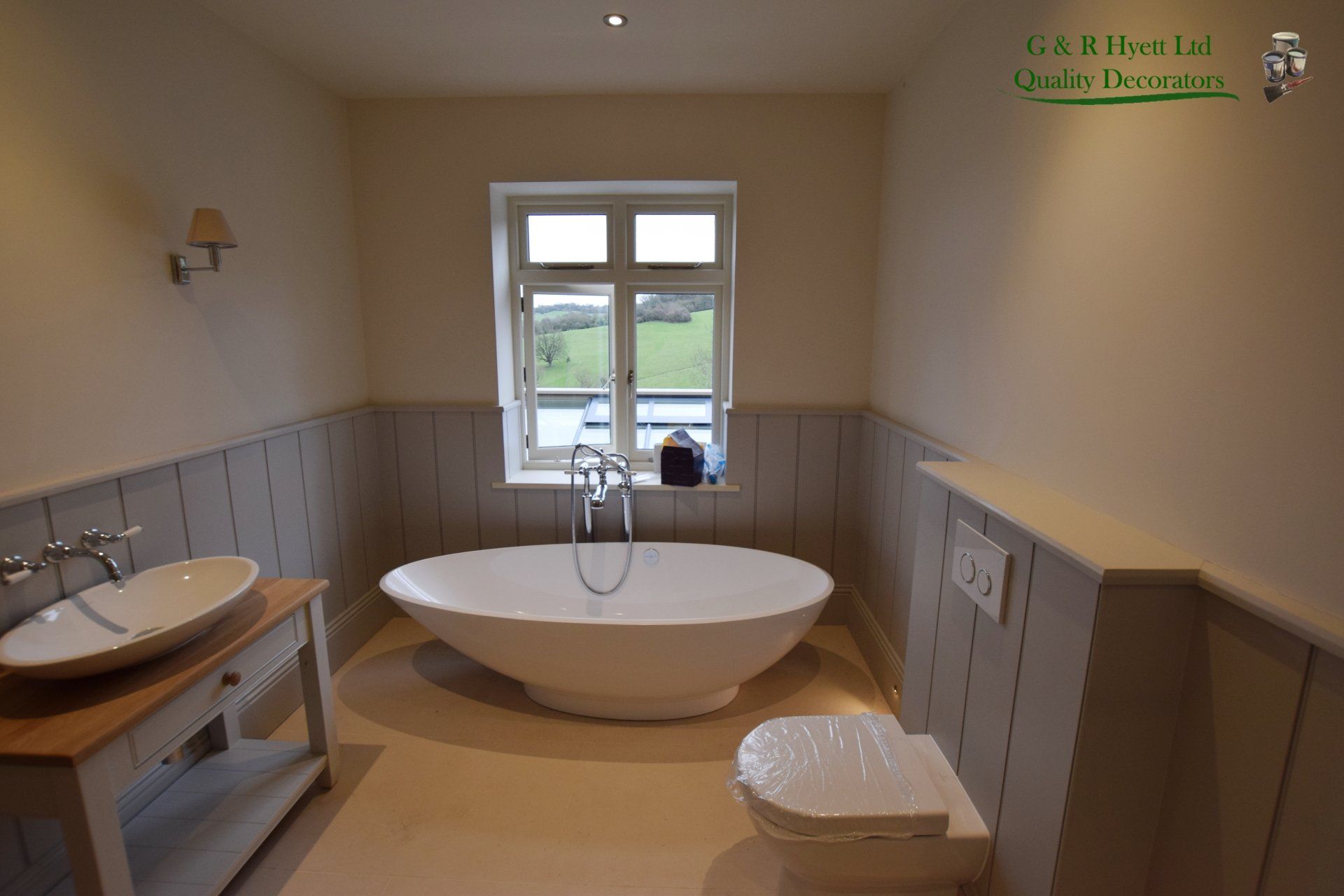 Bathroom in Cheltenham with hand painted paneling and vanity unit, decoration done in Farrow and Ball paint