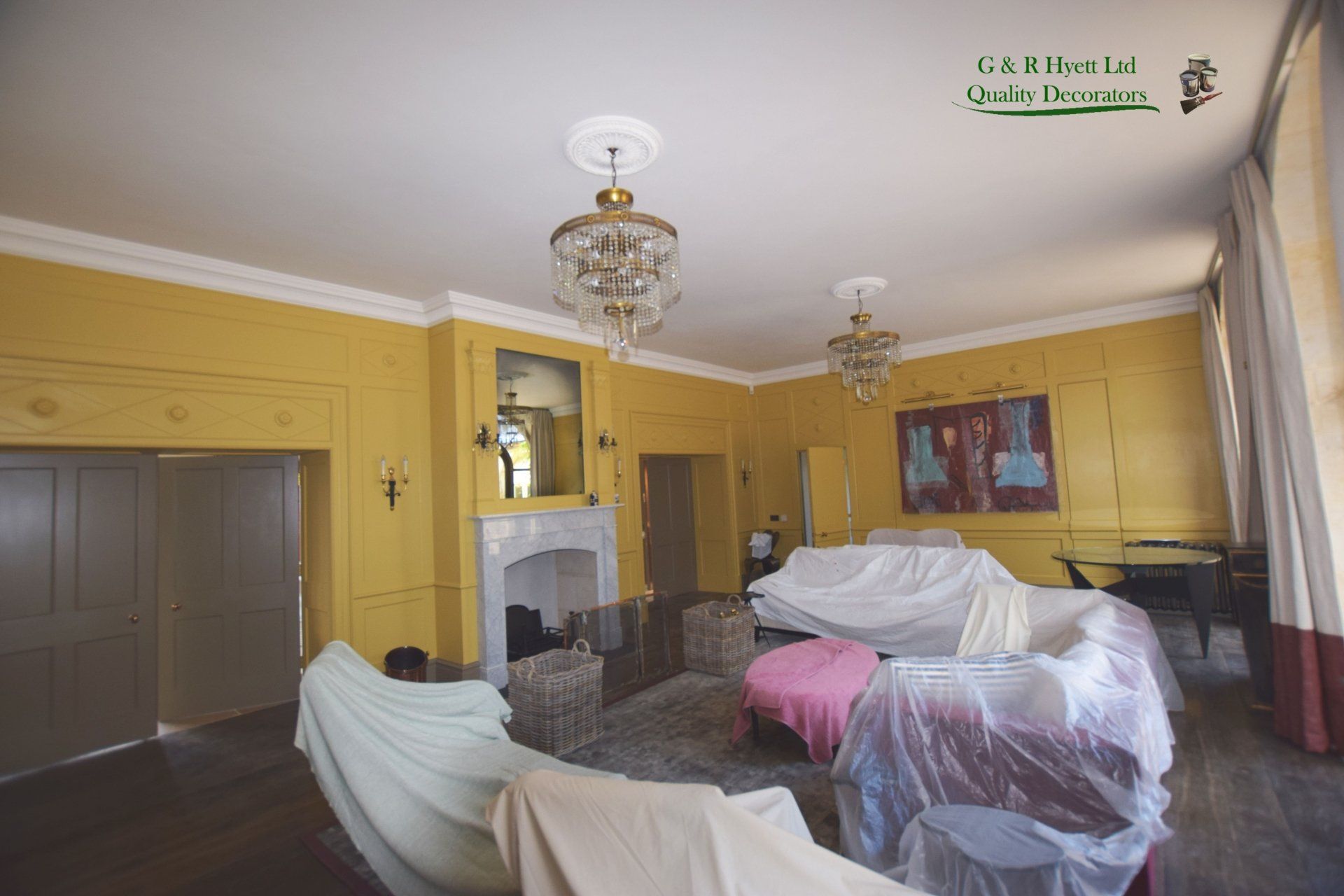 Large lounge with panelled walls, painted with Farrow and Ball Paint