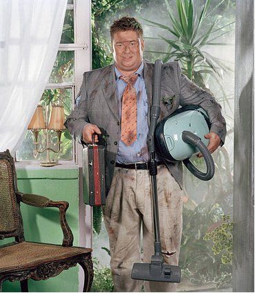dirty man holding vacuums