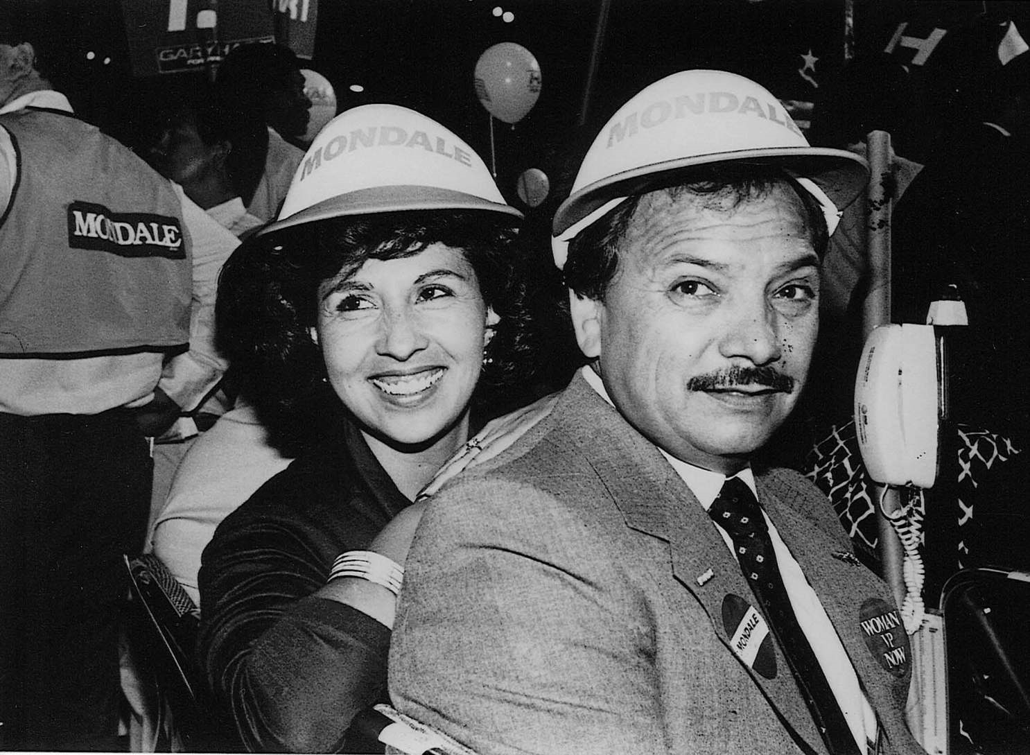 A man and woman wearing hard hats that say monday