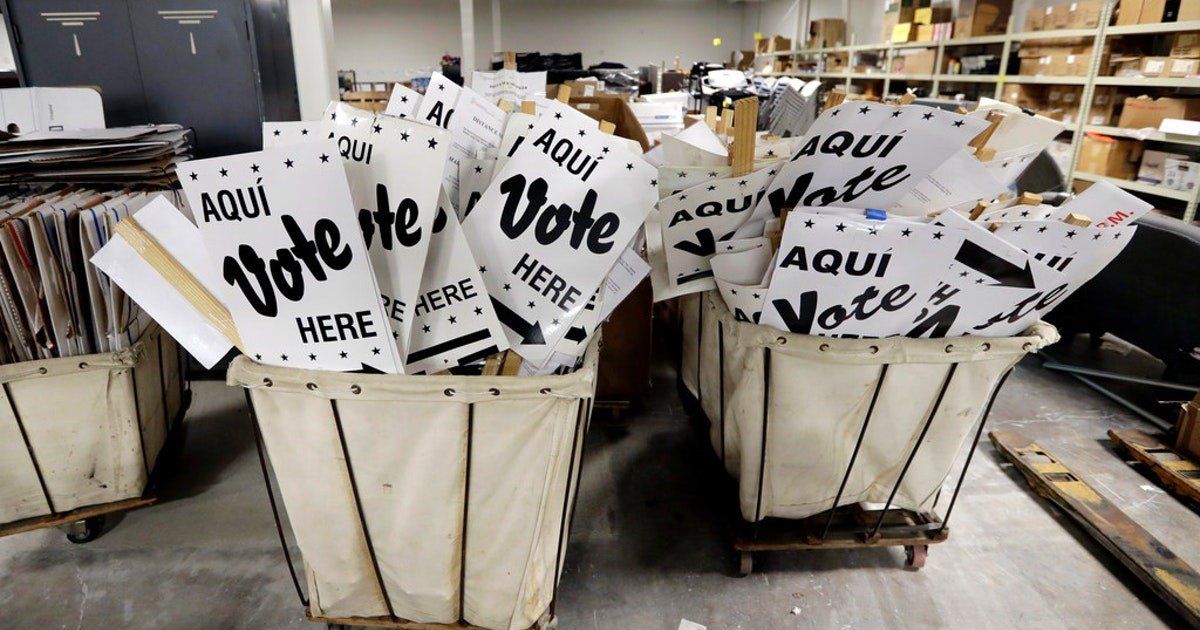 A bunch of baskets filled with signs that say vote here