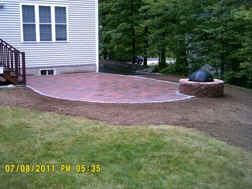 Back yard fire pit side angle in North Attleboro, MA