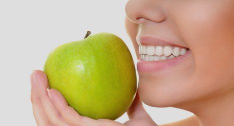 Fruit in hand with strong teeth