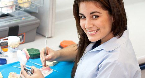 Dentist working on dentures