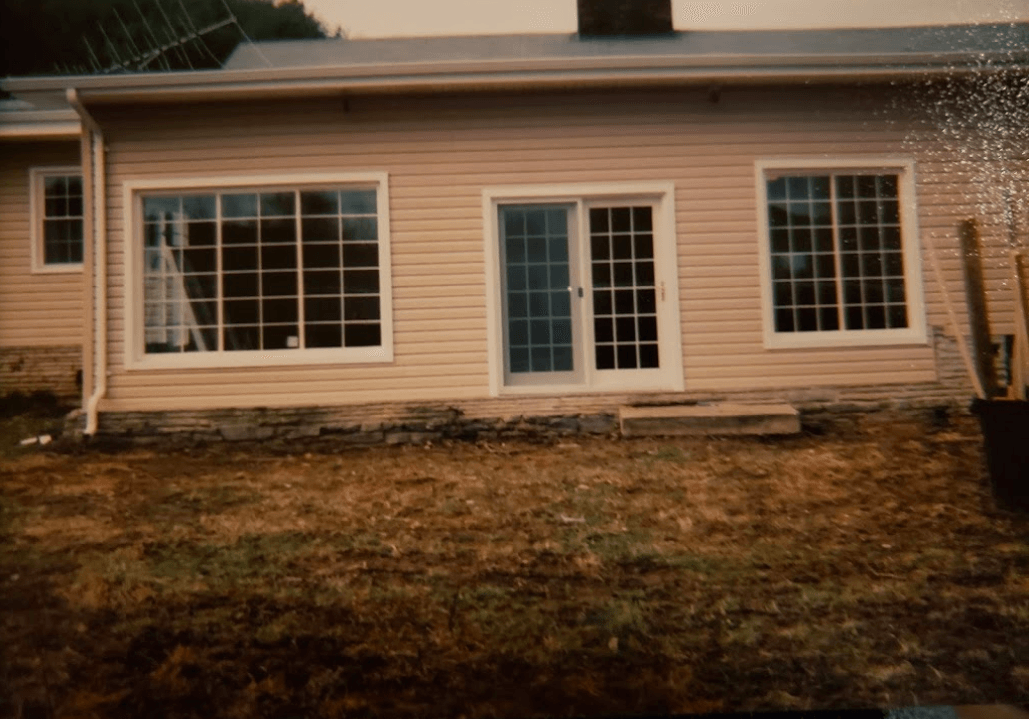 A house with a lot of windows and a sliding glass door.