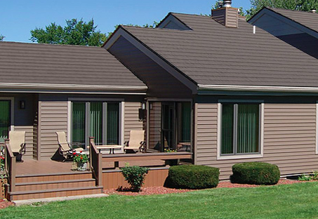 A house with a deck and chairs in front of it