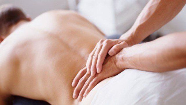 Two hands massaging low back