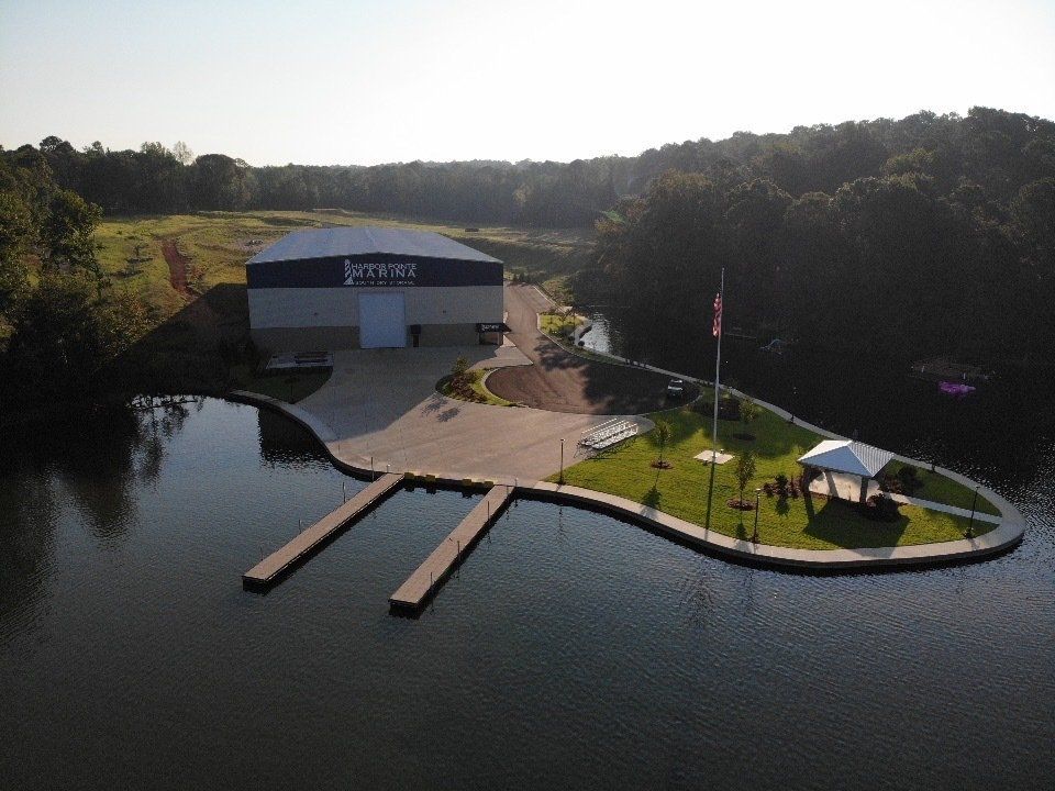 An aerial view of a large body of water with a large building in the background