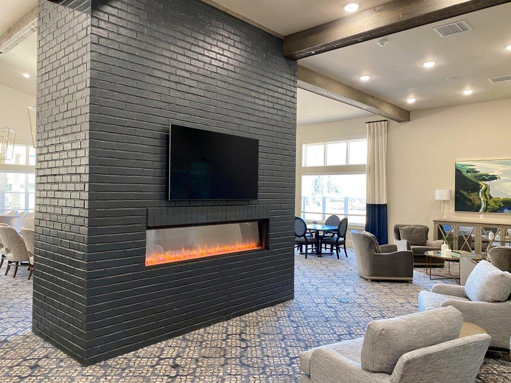 A living room with a fireplace and a flat screen tv.