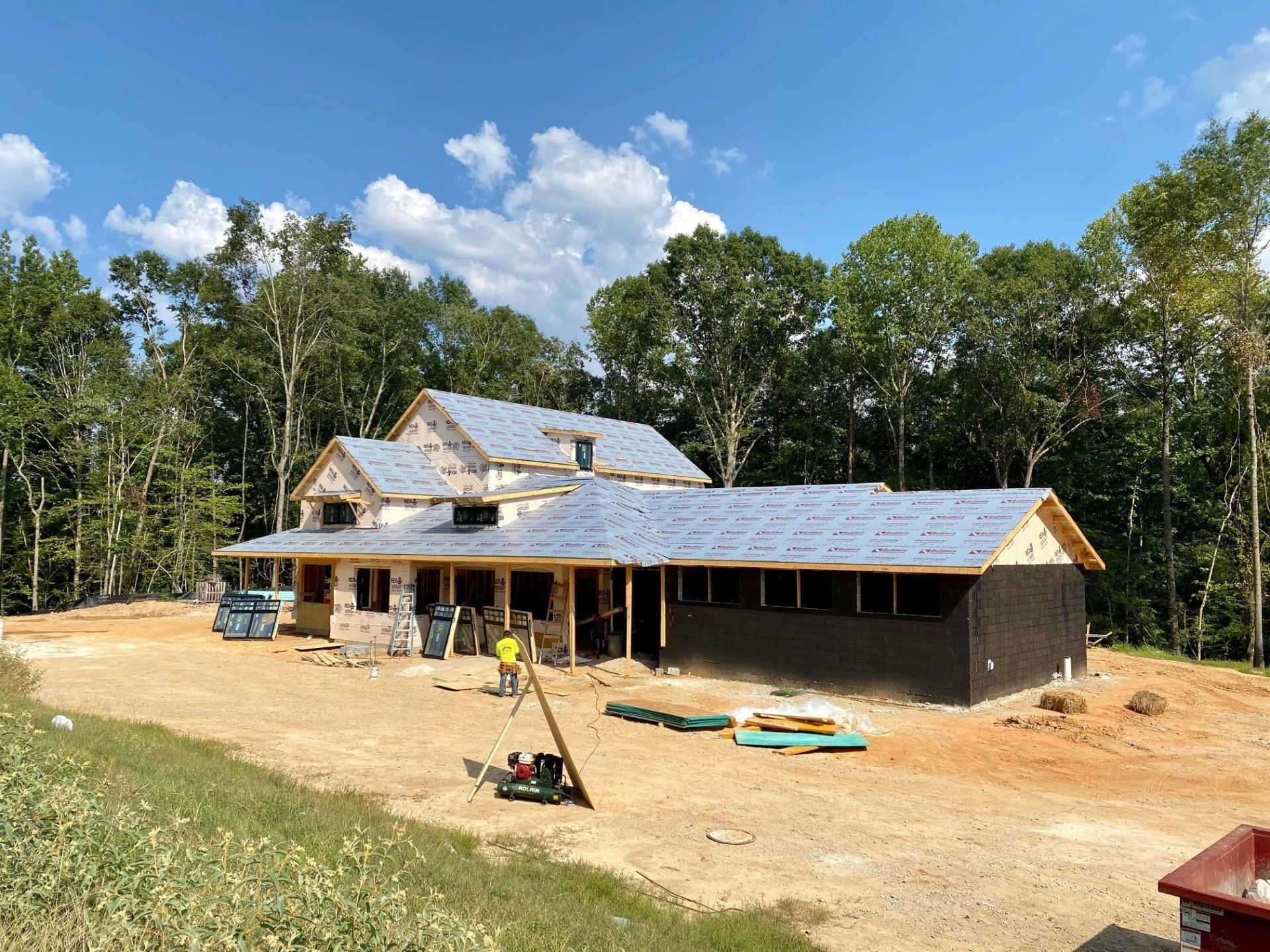 A large house is being built in the middle of a forest.