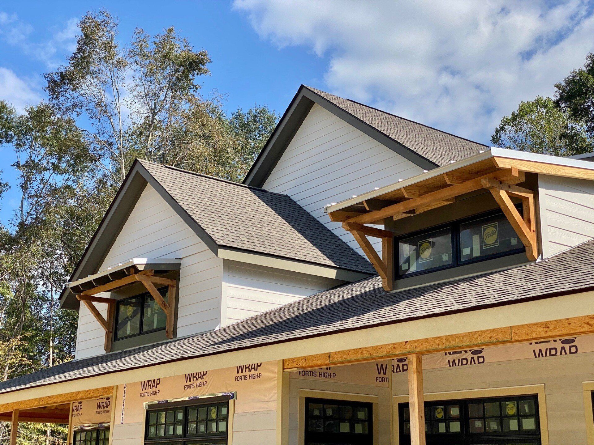 The roof of a house is being built and has a lot of windows.
