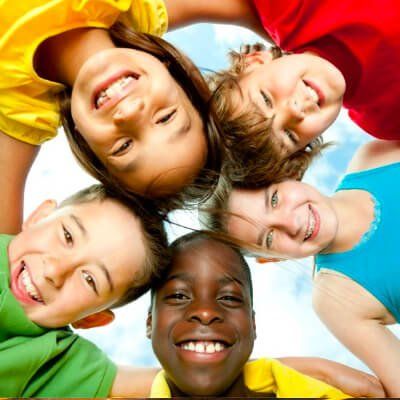 A group of children are posing for a picture with their heads together