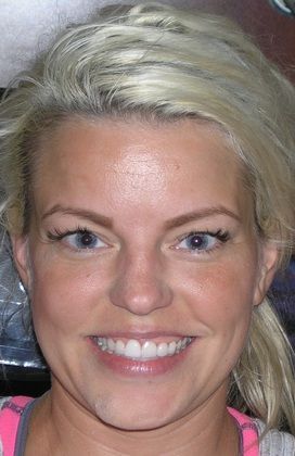 A close up of a woman 's face with a smile on her face.