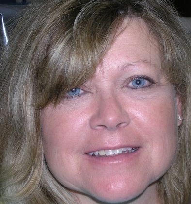 A close up of a woman 's face with blonde hair and blue eyes