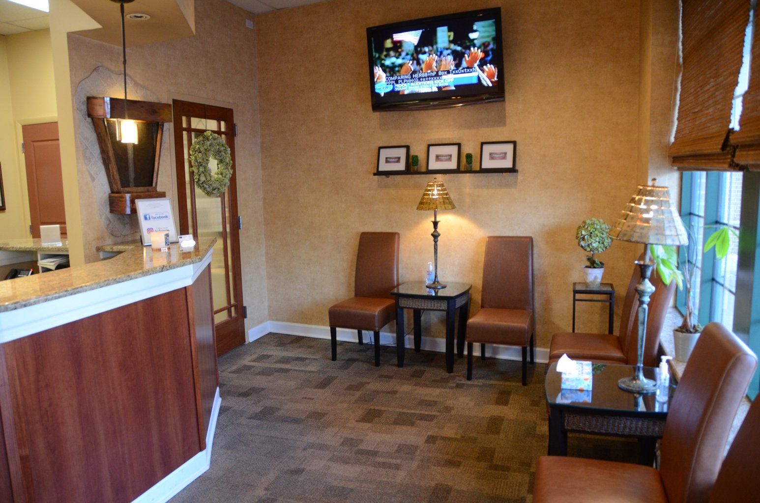 A waiting room with chairs and a flat screen tv