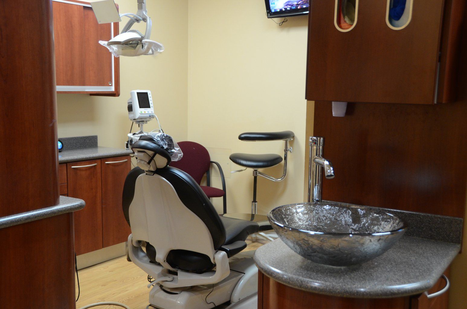 A dental office with a dental chair and a sink