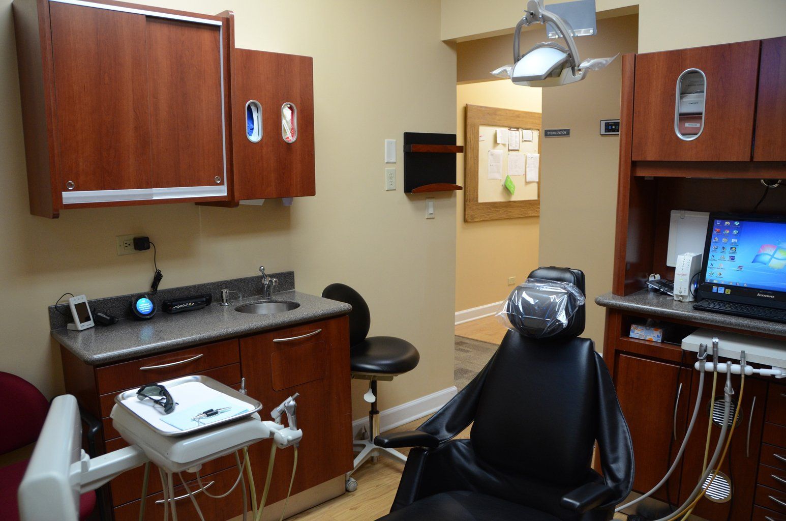 A dental office with a dental chair and a computer