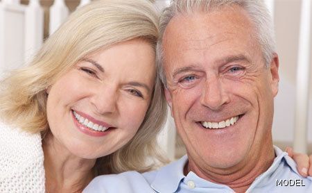 A man and a woman are smiling for the camera.