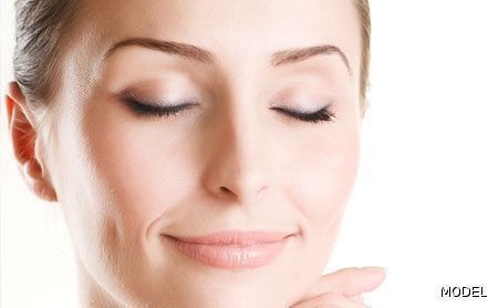 A close up of a woman 's face with her eyes closed.