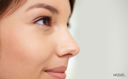 A close up of a woman 's nose and eye.