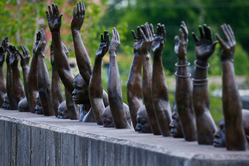 This photo shows a bronze statue called “Raise Up”, part of the display at the National Memorial for Peace and Justice, a new memorial in Montgomery, Ala to honor thousands of people killed in lynchings.