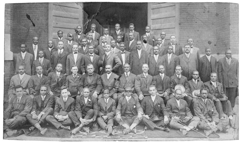 a black and white photo of a group of men in suits
